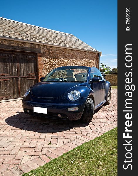 Dirty Convertable parked outside shed with roof down. Dirty Convertable parked outside shed with roof down