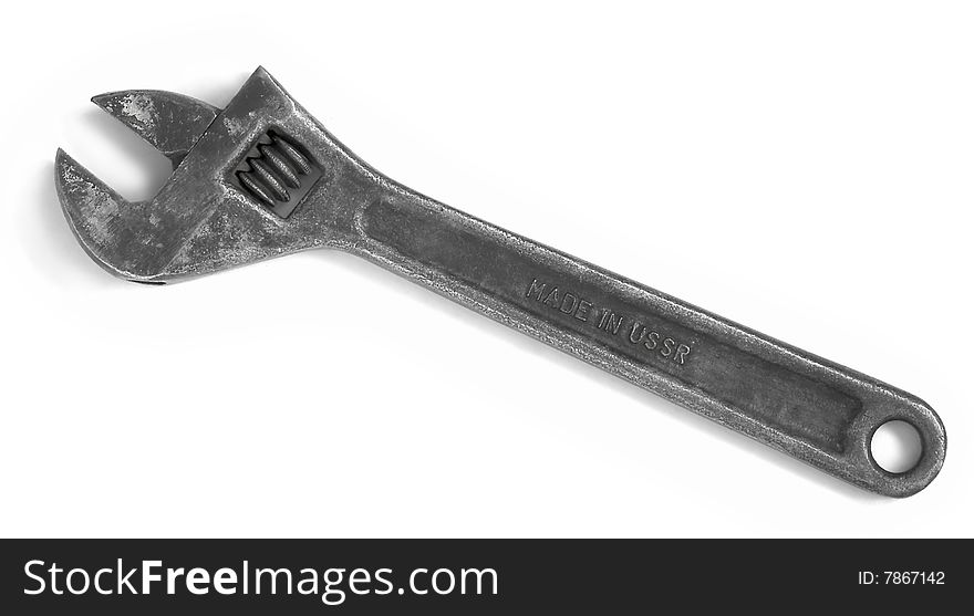 Old adjustable spanner isolated over white. Made in USSR.