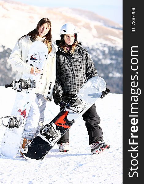 Two young girls keeping snowboards. Two young girls keeping snowboards