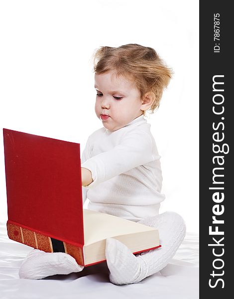 Stock photo: an image of a little girl with a big book. Stock photo: an image of a little girl with a big book