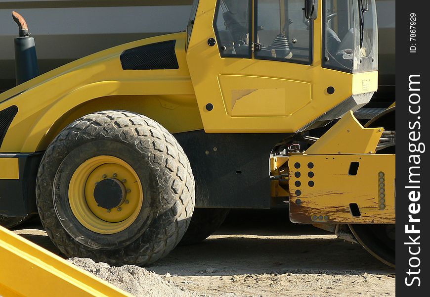 A yellow digger on site. A yellow digger on site