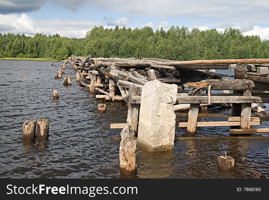 An old broken bridge on a river in Karelia, Russia