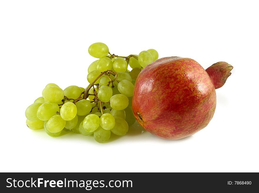 White grapes and pomegranate on white background. White grapes and pomegranate on white background