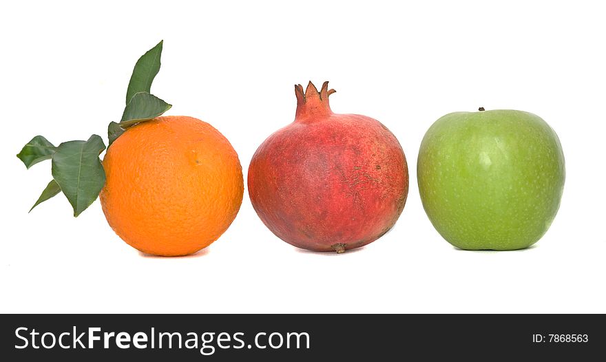 Pomegranate, orange, and apple isolated on white background