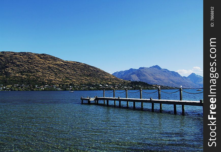 Lake with pier and mountains