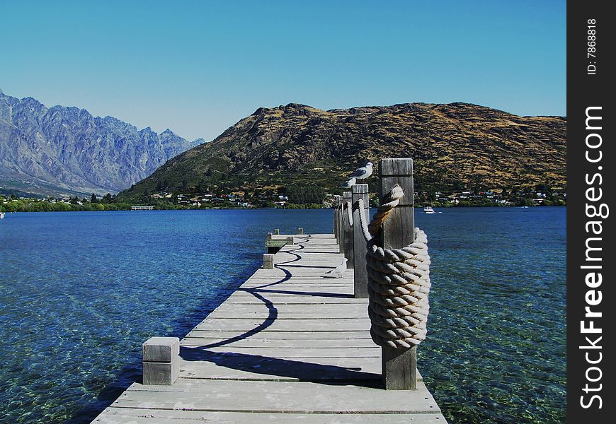 Lake with pier and mountains