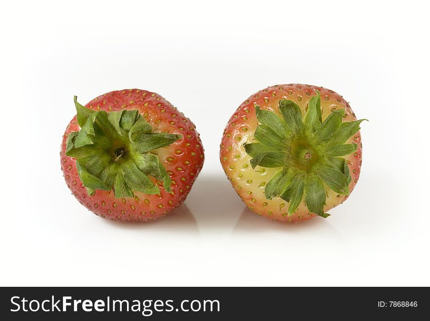 Two red strawberries on white background