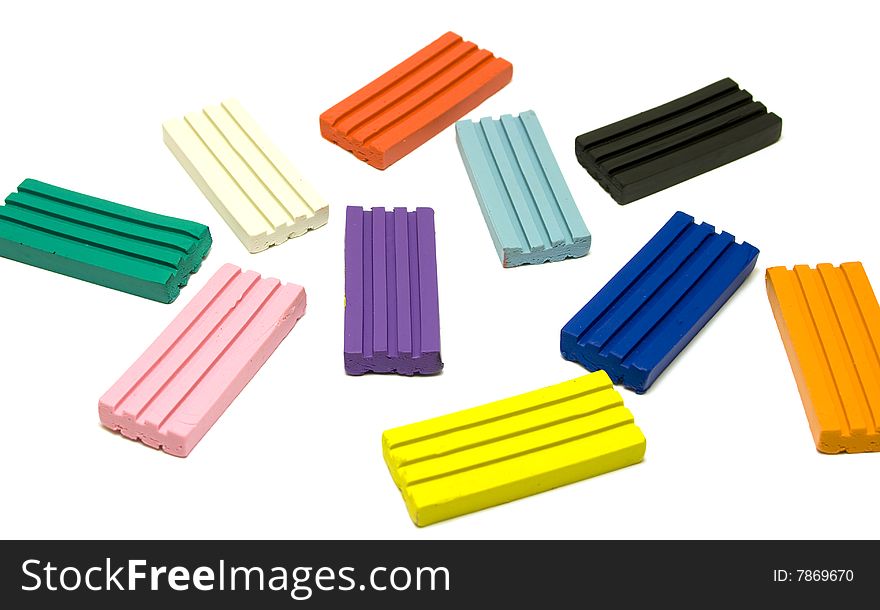 Colorful plasticine bricks on white