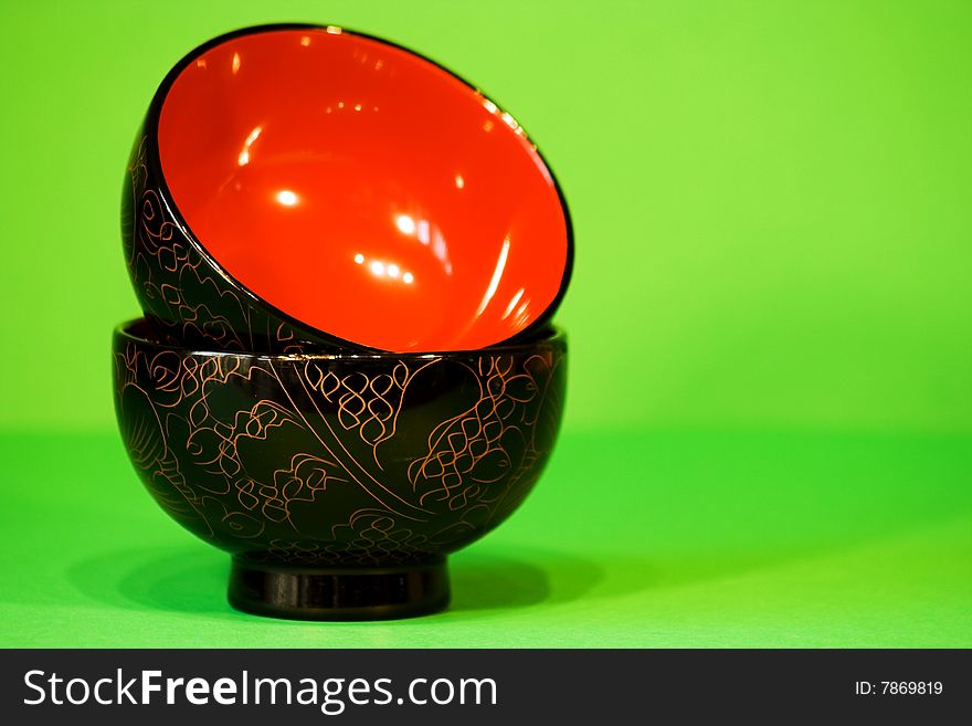 Black and Red Rice Bowls on a Green Background.