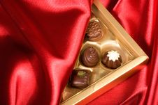 Chocolates Box On Red Satin Royalty Free Stock Photo