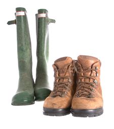 Old Walking Boots And Green Wellington Boots Royalty Free Stock Photography Old Walking Boots And Green Wellington Boots Royalty Free Stock Photography