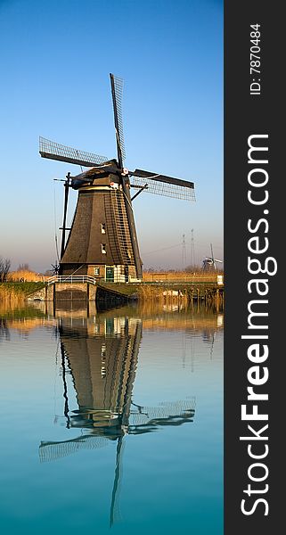 Dutch windmill reflecting on water