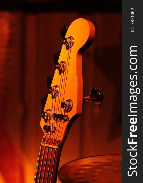 Part of an electric guitar in club atmosphere. Part of an electric guitar in club atmosphere