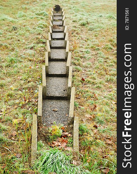 Concrete constructions are in weed, autumn landscape