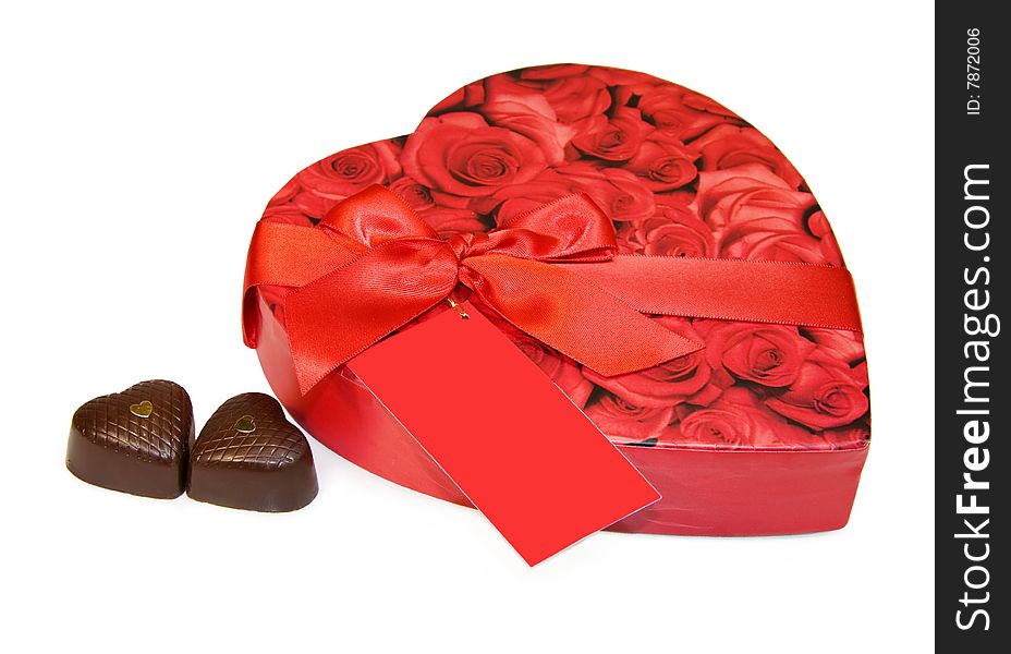 Heart shaped box of chocolates isolated over white with clipping path. Write your own text/design on the red label. Heart shaped box of chocolates isolated over white with clipping path. Write your own text/design on the red label.