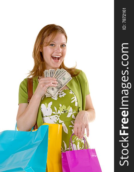 Attractive woman carrying a purse, shopping bags, and a handful of money. Attractive woman carrying a purse, shopping bags, and a handful of money