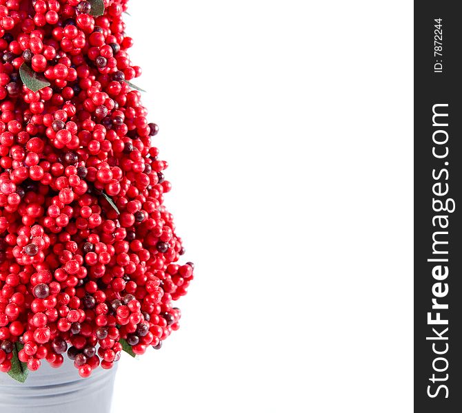 Red berry tree in a small metal pot.