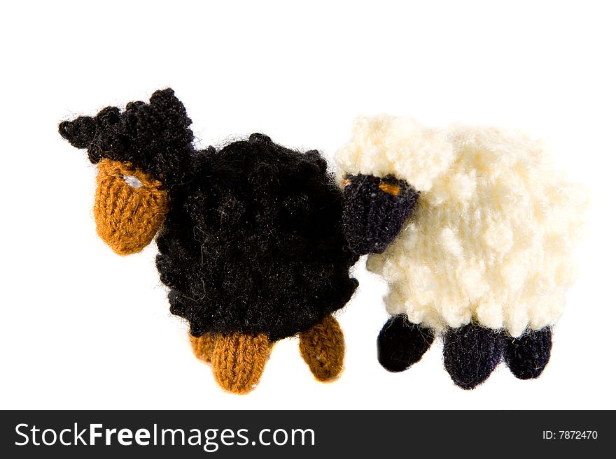 Two small crocheted lambs isolated on white