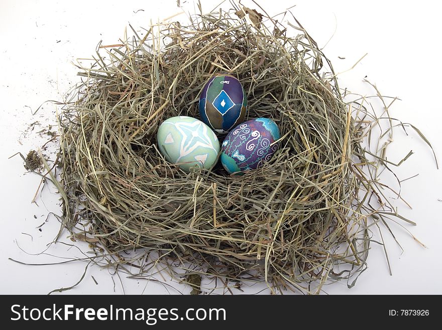 Handmade colored Easter eggs in the nest