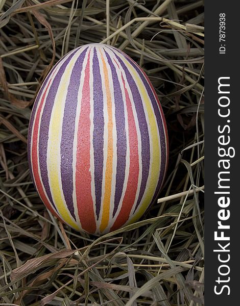 Handmade colored Easter egg in the nest