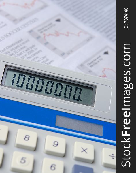 Calculator with financial newspaper in background. Selective focus.