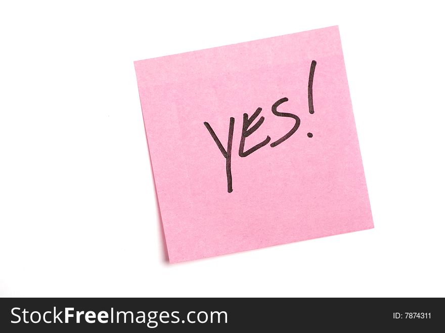 Pink post it note isolated on white with yes written.