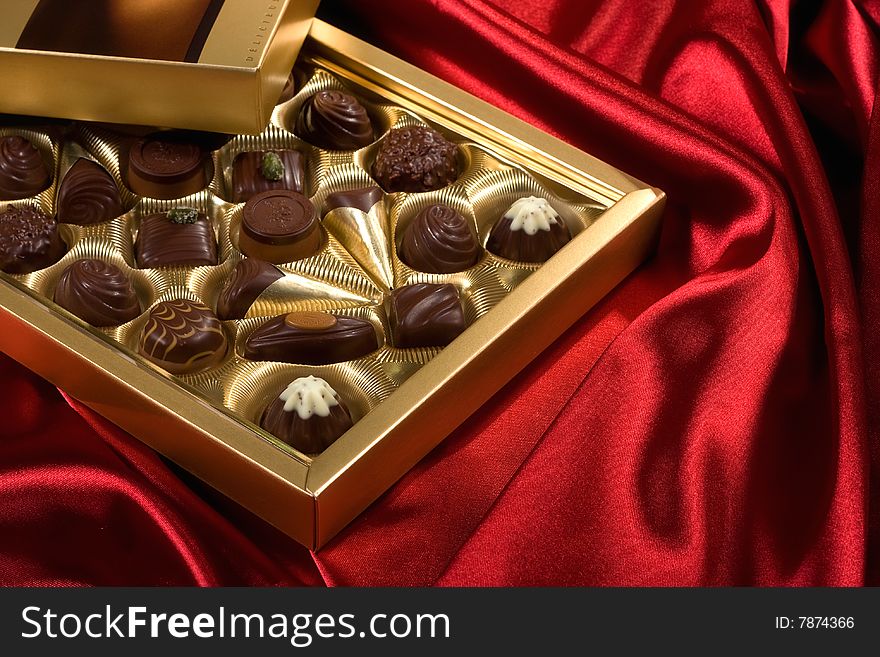 Chocolates box on red satin