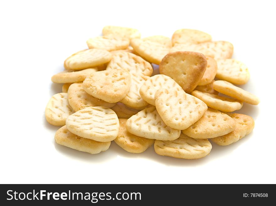 Yellow salty crackers on white ground