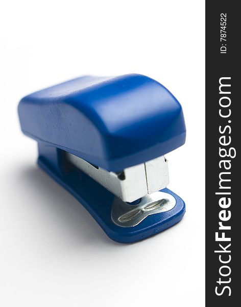 Blue stapler on white background.