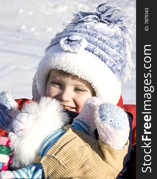 Winter day. Cute little girl on the snow.