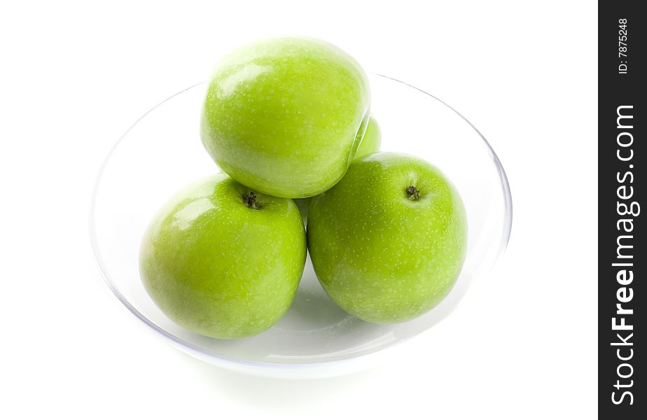 Green apples in glass bowl isolated on white background