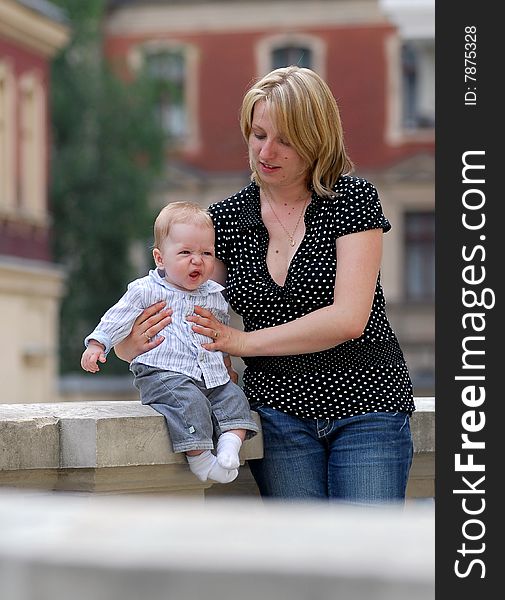 The woman walk with the child in park. The woman walk with the child in park.