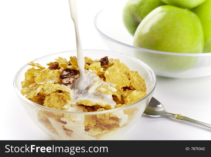 Healthy breakfast: cornflakes with milk and green apples