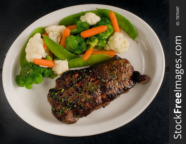 Medium rare, seared steak with steamed vegetables