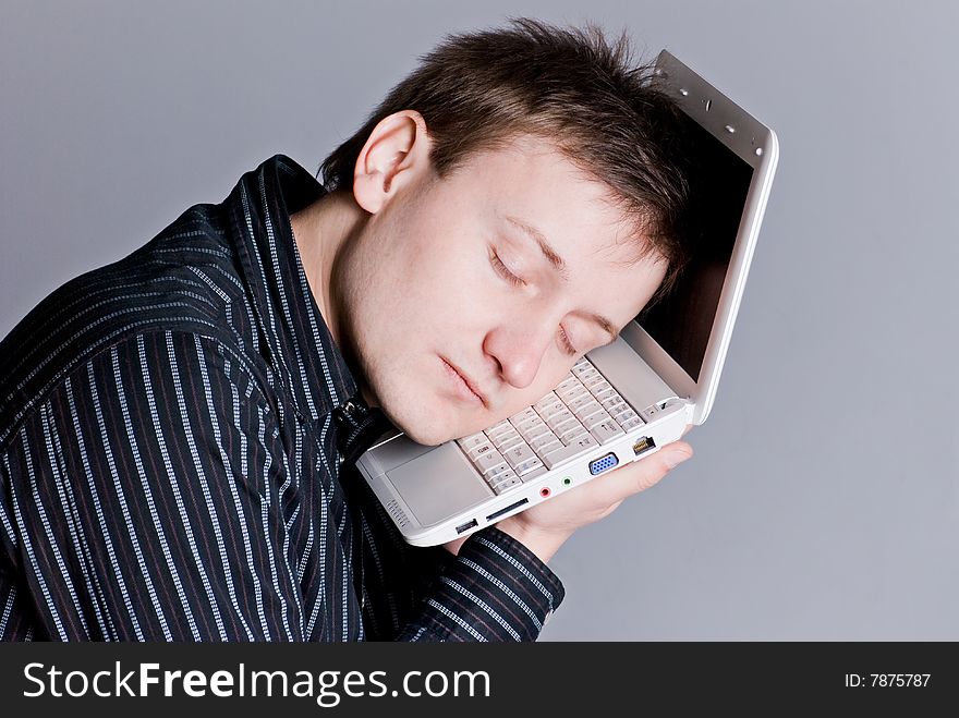 Young the man sleeps on the keyboard notebook. Young the man sleeps on the keyboard notebook