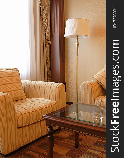 Floor lamp and armchair in a hotel suite