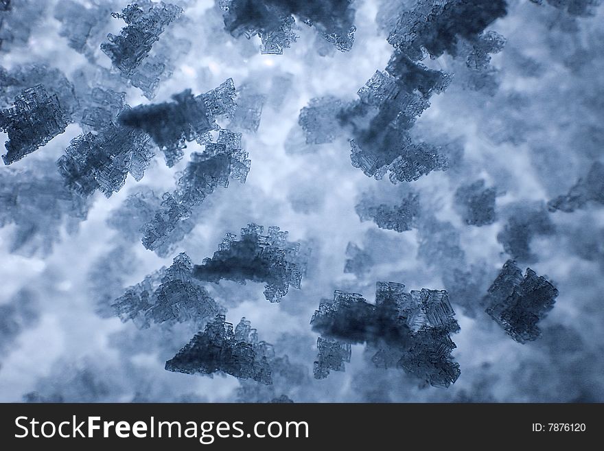 Close-up view of tiny ice crystals in a piece of snow. Close-up view of tiny ice crystals in a piece of snow.
