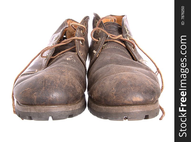 A pair of old worn boots isolated on a white background