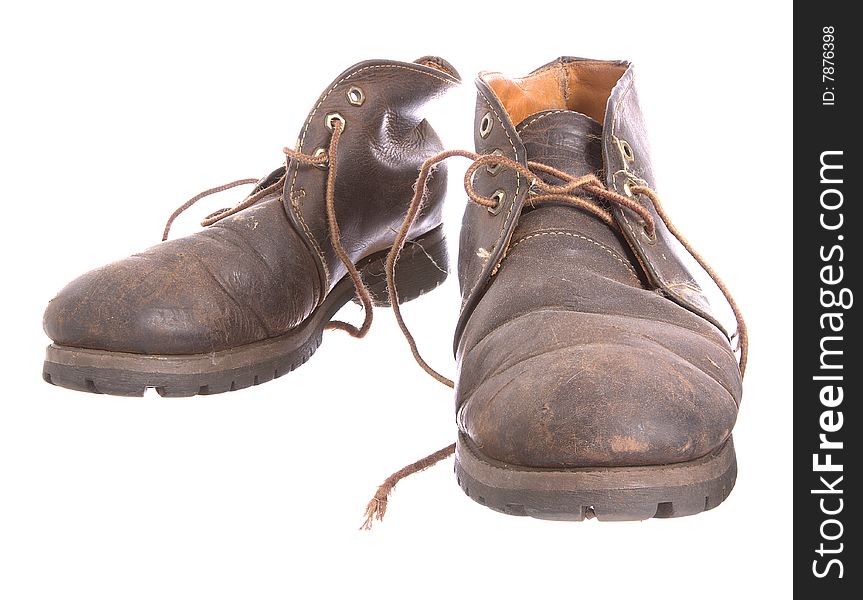 A pair of old worn boots isolated on a white background