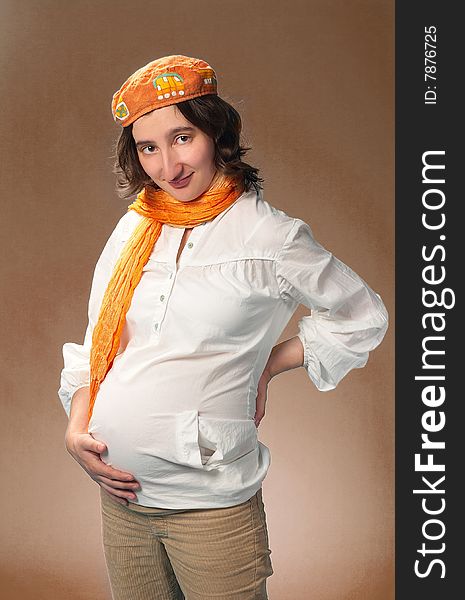 The pregnant woman On a grey background. The pregnant woman On a grey background