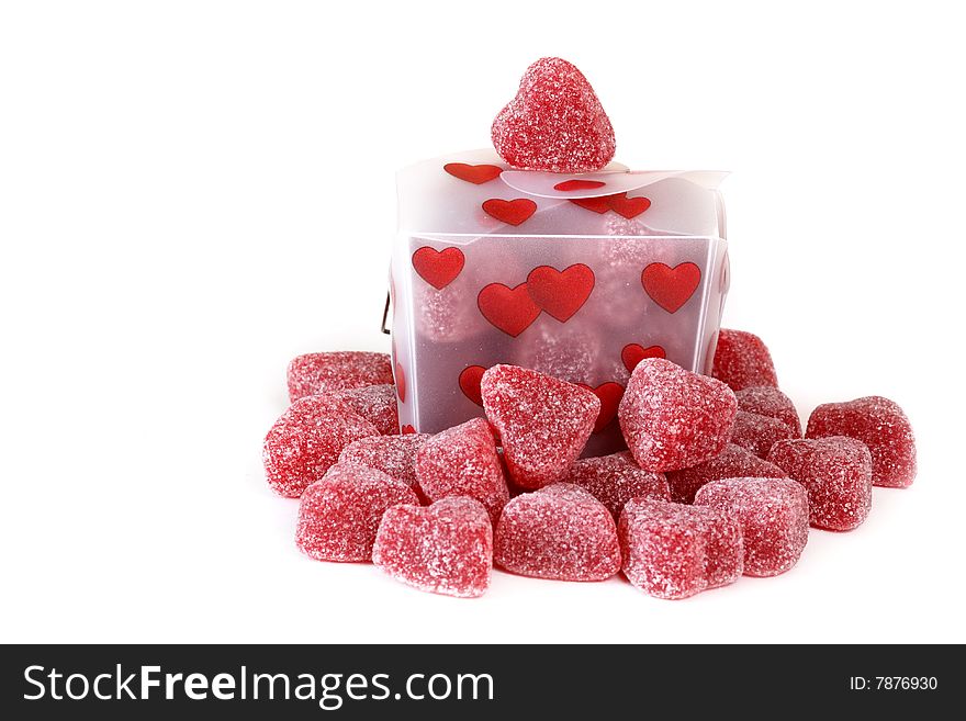 Gummy cinnamon heart surrounding a heart covered Chinese take out style box on an isolated background. Gummy cinnamon heart surrounding a heart covered Chinese take out style box on an isolated background