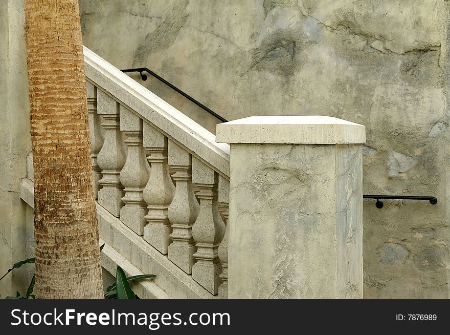 An image of marbled stone railings leading to a terrace