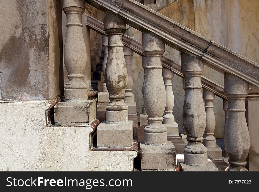 An image of marbled stone railings leading to a terrace