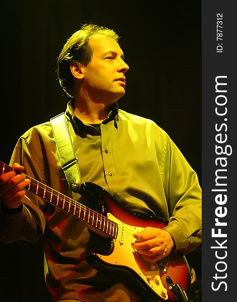 A guitarist performs on stage