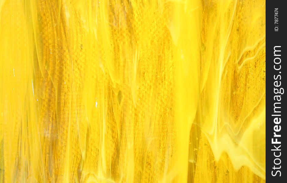 Abstract texture of yellow glass as a background