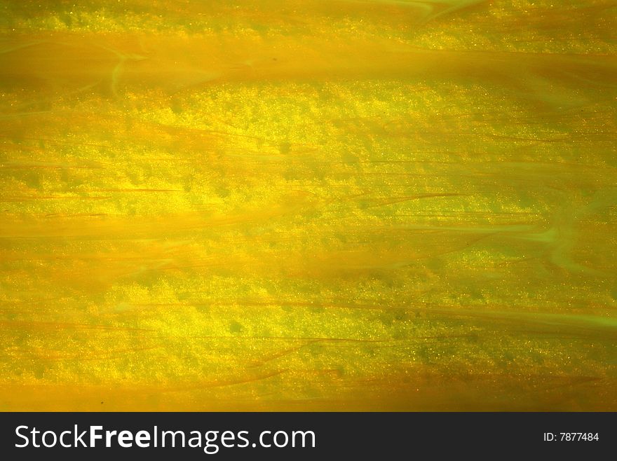 The texture of yellow glass as a background. The texture of yellow glass as a background