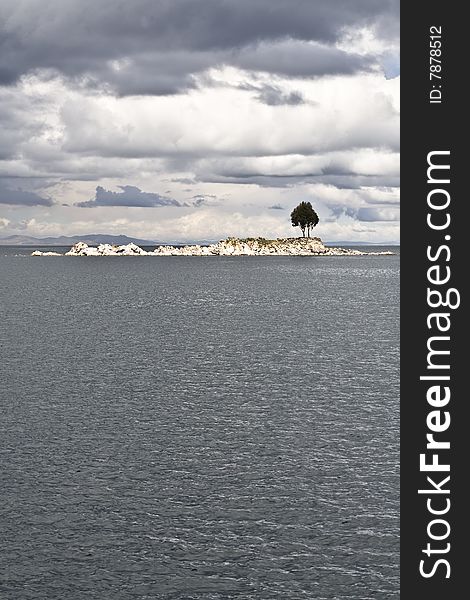 A single tree on and rocky island on Lake Titicaca. A single tree on and rocky island on Lake Titicaca.