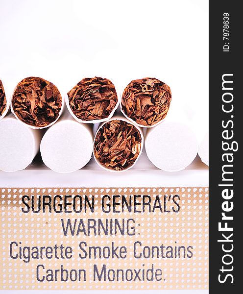 Close view of the cigarettes on the carton with warning sign isolated on white