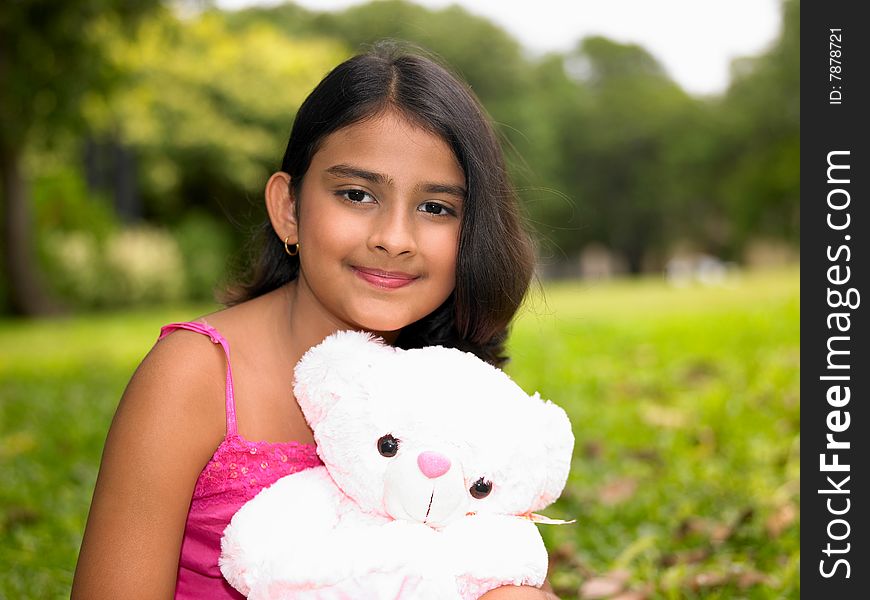 Girl In The Garden With Her Teddy Bear