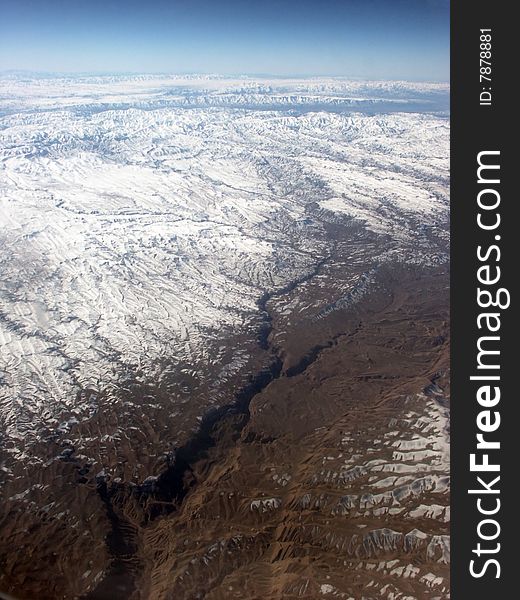 Kashmir. View on the snow hills and valleys from the plane.